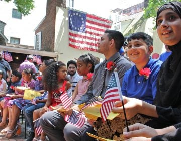 Thirteen children from seven nations took the Oath of Allegience to become U.S. citizens during a naturalization ceremony at the Betsy Ross House in Philadelphia on July 4, 2018. (Emma Lee/WHYY)