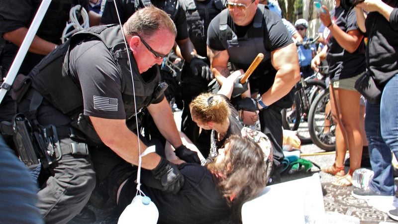 Police make arrests as they clear out a protest encampment near Immigration and Customs Enforcement offices at 8th and Cherry streets. (Emma Lee/WHYY)