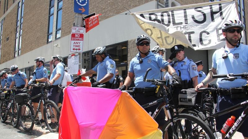 Police create a barricade around Immigration and Customs Enforcement offices on 8th Street after clearing out a protest encampment there. (Emma Lee/WHYY)