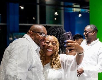 Big Scott, organizer of the All White Affair at Adventure Aquarium in Camden, NJ is pictured with WBAS Radio personality Patty Jackson. (Brad Larrison for WHYY)