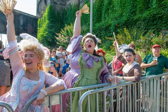 Revelers (from left) Francesca Negron, Ann Patricia, and Katherine Patterson, wear period costumes for the final Bastille Day performance on July 14, 2018. (Jonathan Wilson for WHYY)