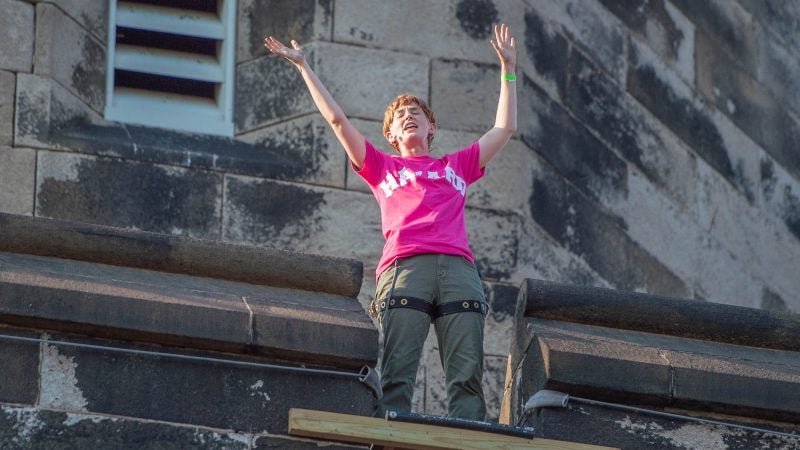 From the tower of the Eastern State Penitentiary, Mark Zuckerberg, played by Mary Tuomanen, sings 