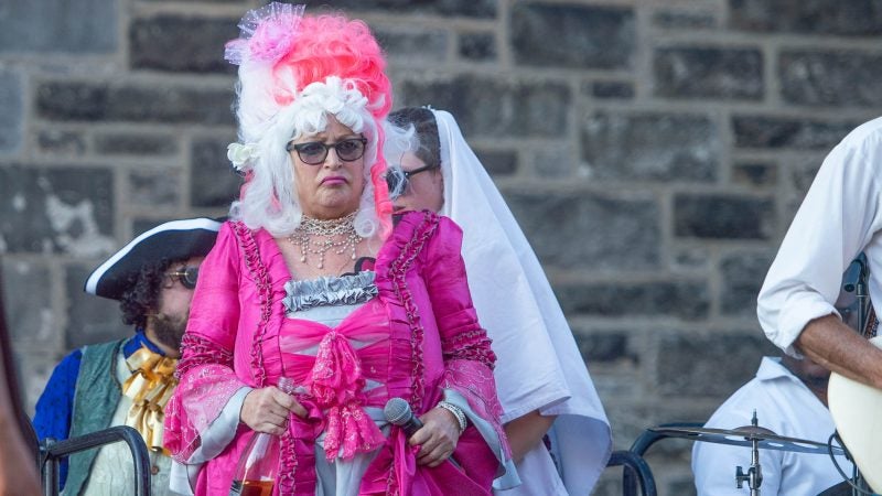 Marie Antoinette, portrayed by Terry McNally, is escorted from the tower to confront Edith Piaf, portrayed by John Jarboe. (Jonathan Wilson for WHYY)