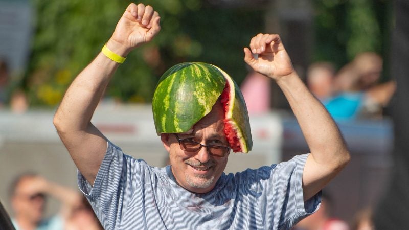 After receiving a watermelon from executioner Sean Kelley, a member of the crowd wears the melon on his head. (Jonathan Wilson for WHYY)