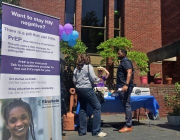 John Rose discusses PrEP with members of the community outside the Joseph E. Coleman Library in Germantown.