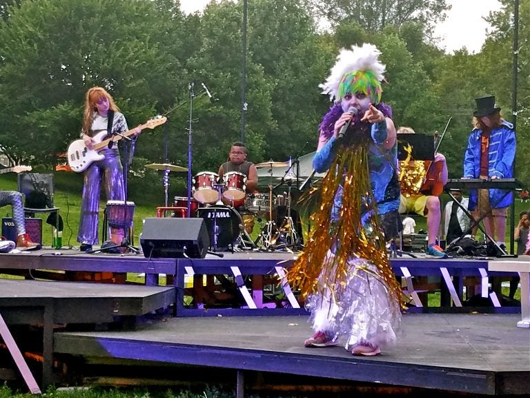 Jess Conda, as Feste, fronts the band Midsummer Madness in a glam rock version of 