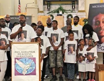 Family members of Michael White, 20, charged in the stabbing death of Sean Schellenger, 37, assemble in the front of True Gospel Tabernacle in South Philadelphia. (Emma Lee/WHYY)