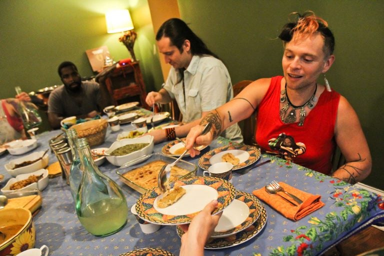 Francis Rose Subbiando serves plantains after a talk on the history of Creole Philadelphia at a Faemily Table dinner at her home in West Philadelphia. (Kimberly Paynter/WHYY)