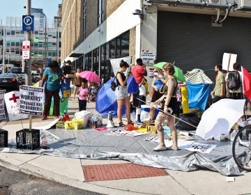 Demonstrators protest ICE outside of the office at Eighth and Cherry streets in Philadelphia. (Kimberly Paynter/WHYY)