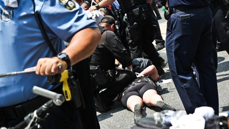 Police arrest protesters at Philadelphia’s ICE office at Eighth and Cherry streets around noon Tuesday. (Kimberly Paynter/WHYY)