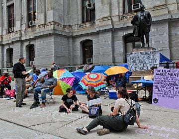 Immigration policy protesters have moved from the ICE headquarters at Eighth and Cherry streets to City Hall and are asking Philadelphia Mayor Jim Kenney to end an agreement with ICE. (Kimberly Paynter/WHYY)