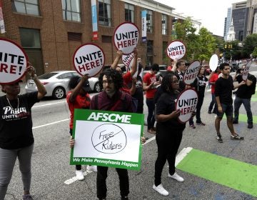 Union activists stand in the road as they participate in a protest by the Philadelphia Council AFL-CIO Wednesday June 27, 2018 in Philadelphia. The protesters denounced Wednesday's U.S. Supreme Court ruling that government workers can't be forced to contribute to labor unions that represent them in collective bargaining, dealing a serious financial blow to organized labor. (AP Photo/Jacqueline Larma)