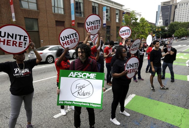 Union activists stand in the road as they participate in a protest by the Philadelphia Council AFL-CIO Wednesday June 27, 2018 in Philadelphia. The protesters denounced Wednesday's U.S. Supreme Court ruling that government workers can't be forced to contribute to labor unions that represent them in collective bargaining, dealing a serious financial blow to organized labor. (AP Photo/Jacqueline Larma)