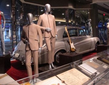 This July 5, 3018 photo shows suits worn by the Beatles during an early tour of America in front of the Rolls Royce automobile owned by Elvis Presley, part of a large collection of music memorabilia on display at the Hard Rock casino in Atlantic City, N.J. (Wayne Parry/AP Photo)