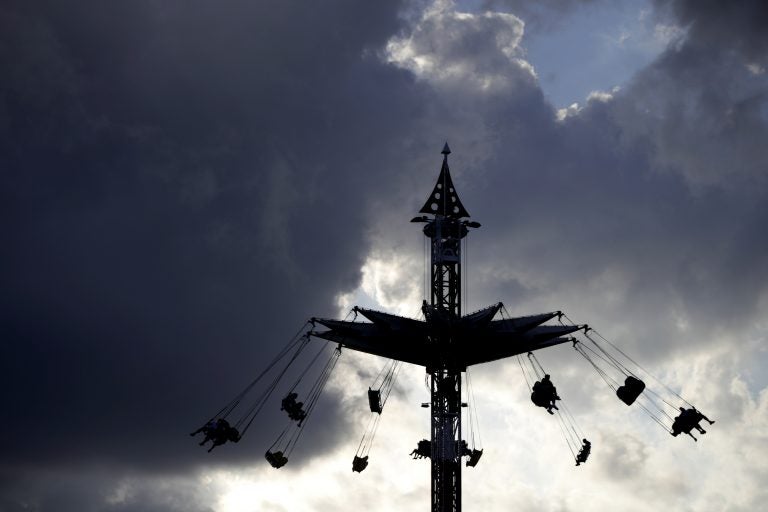 People ride on the Sky Flyer at the State Fair Meadowlands carnival on July 5 in East Rutherford, N.J. (AP Photo/Julio Cortez)