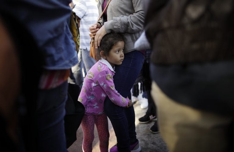 In this June 13, 2018 file photo, Nicole Hernandez, of the Mexican state of Guerrero, holds on to her mother as they wait with other families to request political asylum in the United States, across the border in Tijuana, Mexico. he separation of families at the U.S.-Mexico border caught the attention of the world and prompted mass outrage, but it only tells a small part of the story surrounding the Trump administration’s immigration policy. (Gregory Bull/AP Photo, file)