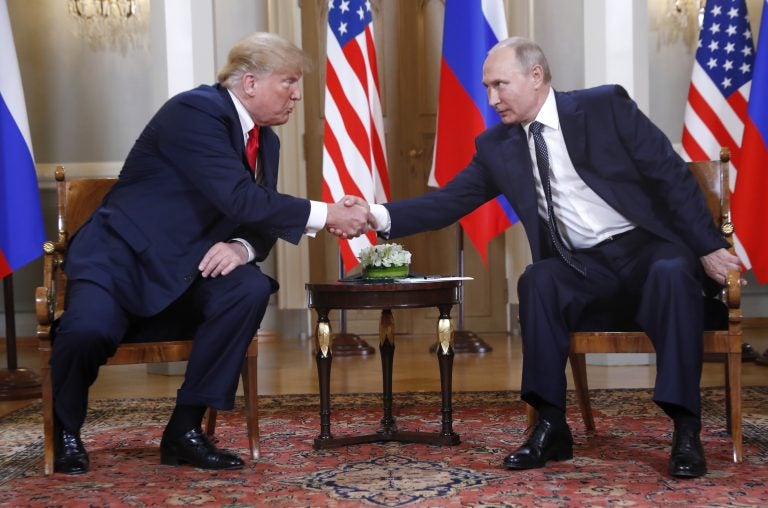 U.S. President Donald Trump, left, and Russian President Vladimir Putin shake hand at the beginning of a meeting at the Presidential Palace in Helsinki, Finland, Monday, July 16, 2018. (