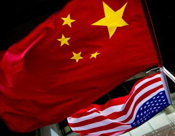 In this Nov. 7, 2012 photo, U.S. and Chinese national flags are hung outside a hotel during the U.S. Presidential election event, organized by the U.S. embassy in Beijing. As public evidence mounts that the Chinese military is responsible for stealing massive amounts of U.S. government data and corporate trade secrets, the Obama administration is eyeing fines and other trade actions it may take against Beijing or any other country guilty of cyberespionage. The Chinese government, meanwhile, has denied involvement in the cyber-attacks tracked by Mandiant. Instead, the Foreign Ministry said that China, too, is a victim of hacking, some of it traced to the U.S. Foreign Ministry spokesman Hong Lei cited a report by an agency under the Ministry of Information Technology and Industry that said in 2012 alone that foreign hackers used viruses and other malicious software to seize control of 1,400 computers in China and 38,000 websites. (AP Photo/Andy Wong)