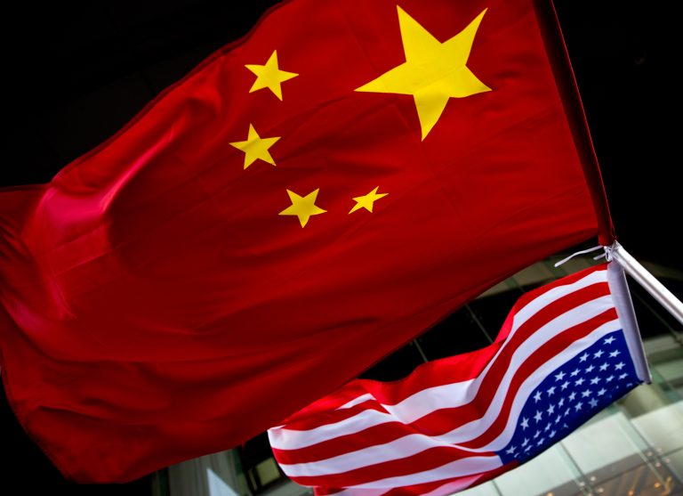 In this Nov. 7, 2012 photo, U.S. and Chinese national flags are hung outside a hotel during the U.S. Presidential election event, organized by the U.S. embassy in Beijing. As public evidence mounts that the Chinese military is responsible for stealing massive amounts of U.S. government data and corporate trade secrets, the Obama administration is eyeing fines and other trade actions it may take against Beijing or any other country guilty of cyberespionage. The Chinese government, meanwhile, has denied involvement in the cyber-attacks tracked by Mandiant. Instead, the Foreign Ministry said that China, too, is a victim of hacking, some of it traced to the U.S. Foreign Ministry spokesman Hong Lei cited a report by an agency under the Ministry of Information Technology and Industry that said in 2012 alone that foreign hackers used viruses and other malicious software to seize control of 1,400 computers in China and 38,000 websites. (AP Photo/Andy Wong)