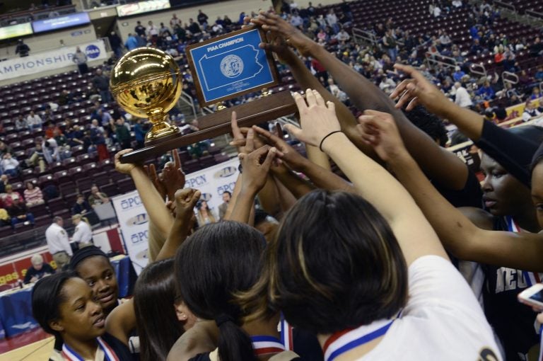Neumann-Goretti players reach for the championship trophy at the end of a PIAA high school Class AA Girls championship basketball game against Seton LaSalle in Hershey, Pa. on Friday, March 20, 2015. Nuemann-Goretti won 79 - 34.