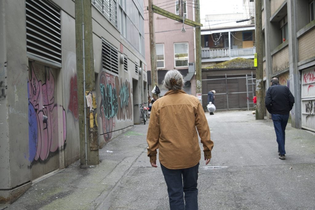 Longtime Vancouver resident and activist Ann Livingston in the alley next to the former space of the Vancouver Area Network of Drug Users, a group she helped found. Photo by Elana Gordon, WHYY