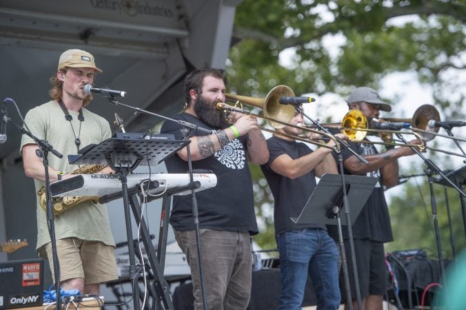 Max Swan, left, performs with his band on the Chill Moody Stage.  (Jonathan Wilson for WHYY)