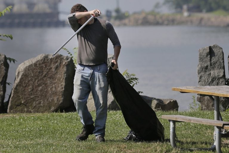 Robert Gidney wipes away sweat while working in Palisades Interstate Park in Ft. Lee, N.J., Monday, July 2, 2018. The National Weather Service has most of New Jersey state under an excessive heat warning or heat advisory, with heat indices predicted to top 100 degrees.