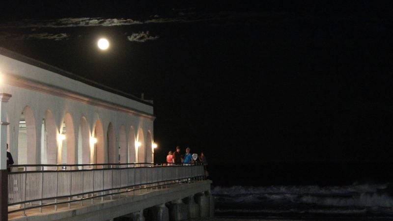 A small crowd gathers at the end of the Ocean City Music Pier to watch the moon rise. (Bill Barlow/for WHYY)