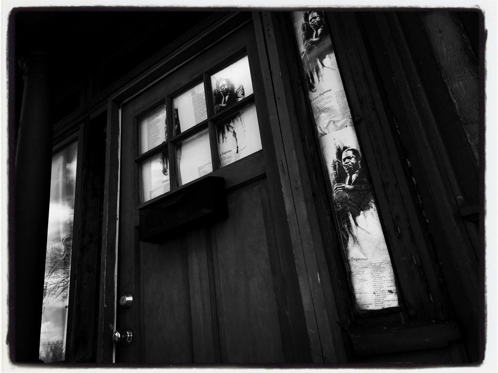 Liner notes to Coltrane's masterpiece, "A Love Supreme" are taped to the small windows on either side of the front door. 