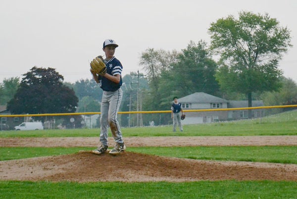 Twelve-year-old Jarryn Myers prepares to pitch. Two years ago, Myers lost his father to a heroin overdose. Jarryn helped police to find the man who sold his dad the fatal dose. (Brett Sholtis/Transforming Health)