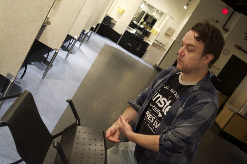 Insite’s clinic coordinator, Tim Gauthier, demonstrates how staff respond to an overdose in the main injection room. No one has ever died in here or any other injection site. / Photo by Elana Gordon, WHYY