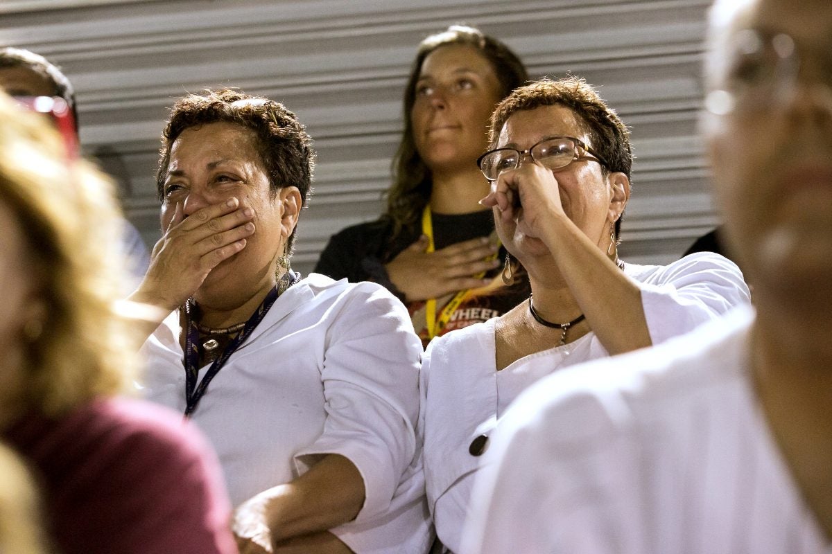 Twin sisters Lee Ann Riley, left, and Linda Riley watch the Cadets' first home performance. It was the first time they had seen the corps perform in decades.