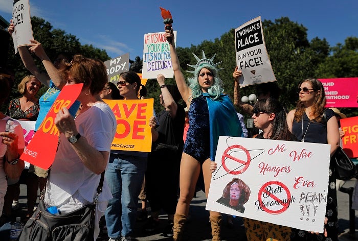 Women demonstrate during a pro-choice rally, Tuesday, July 10, 2018, in New York. Many Democrats and abortion-rights supporters believe a new conservative justice could tilt the court in favor of overturning Roe v. Wade. (AP Photo/Julie Jacobson)