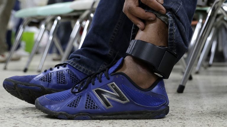 An immigrant wears an ankle monitor as he sits at a shelter in McAllen, Texas after he was released after processing by U.S. Customs and Border Protection. (Eric Gay/AP)