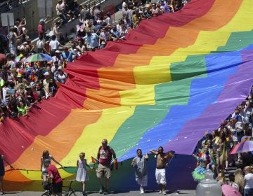 Marchers carry an LGBTQ pride flag during the Utah Pride Parade in Salt Lake City in June.
(Rick Bowmer/AP)