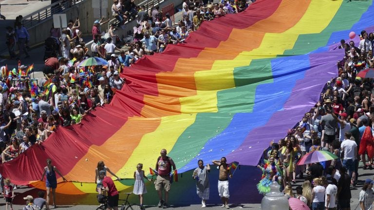 Marchers carry an LGBTQ pride flag during the Utah Pride Parade in Salt Lake City in June.
(Rick Bowmer/AP)