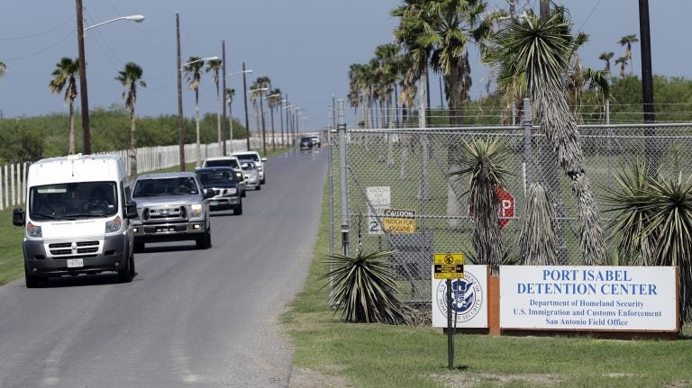 All day, unmarked white vans and chartered buses carrying the migrant children released from shelters across the country roll into the parking lot of the Port Isabel Detention Center in south Texas. (David J. Phillip/AP)