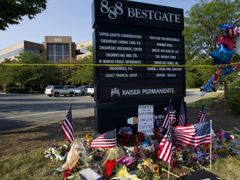 A makeshift memorial is seen at the scene outside the office building housing The Capital Gazette newspaper in Annapolis, Md., on Sunday.