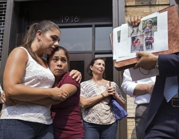 Yeni Gonzalez (center), a Guatemalan mother who was separated from her three children at the U.S.-Mexico border, is embraced by volunteer Janey Pearl Starks as pictures of other children separated from their families are displayed during a news conference on Tuesday in New York City. Gonzalez saw her children in a New York City facility for the first time since mid-May. (Craig Ruttle/AP)