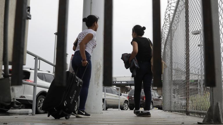 Sisters from Guatemala seeking asylum, cross a bridge to a port of entry in to the United States from Matamoros, Mexico, in Brownsville, Texas. (Eric Gay/AP)