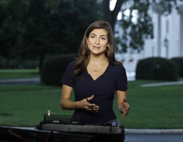 CNN White House correspondent Kaitlan Collins talks during a live shot in front of the White House on Wednesday. Collins says the White House denied her access to an open press event because officials found her earlier questions to the president 