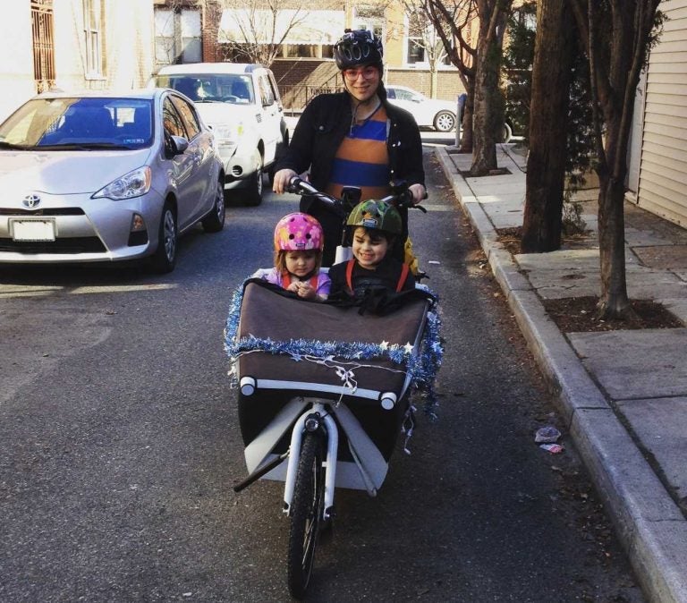 Dena Driscoll and her children try to navigate their way to summer camp, blocked by sidewalk parking at 12th Street and Washington Avenue.