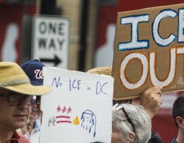 People hold up signs July 16 in Washington, D.C., as they protest ICE. Getting rid of the agency has become a popular rallying cry among progressives, but the House on Wednesday overwhelmingly passed a symbolic measure voicing support for ICE. (Andrew Caballero-Reynolds/AFP/Getty Images)