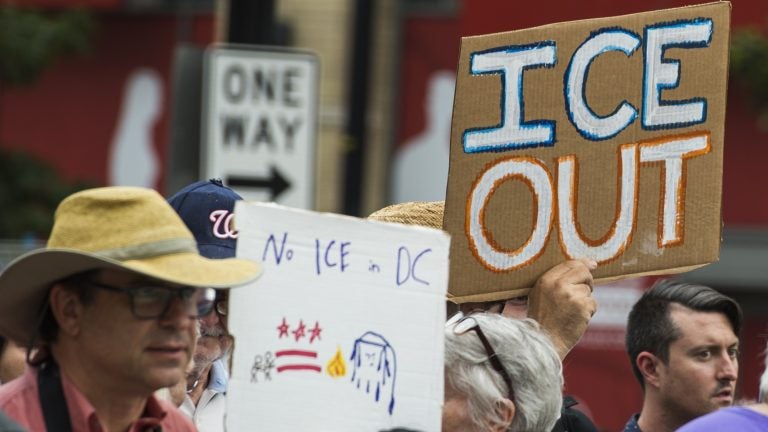 People hold up signs July 16 in Washington, D.C., as they protest ICE. Getting rid of the agency has become a popular rallying cry among progressives, but the House on Wednesday overwhelmingly passed a symbolic measure voicing support for ICE. (Andrew Caballero-Reynolds/AFP/Getty Images)