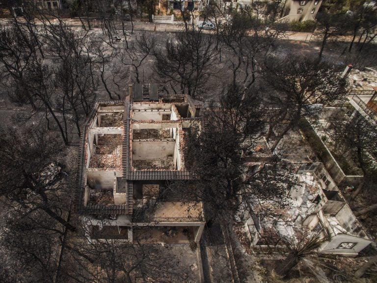 An aerial view shows burned-out houses after a wildfire hit the village of Mati, near Athens. The raging fires have killed at least 50 people in Greece, devouring homes and forests as terrified residents fled to the sea to escape the flames. (Savvas Karmaniolas/AFP/Getty Images)