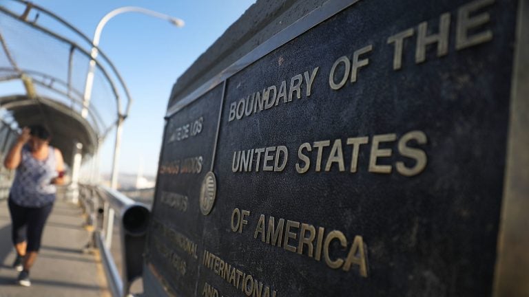 A plaque marks the U.S. border on the Paso Del Norte Port of Entry bridge which connects the U.S. and Mexico on July 23, 2018. As many as 2,551 migrant children ages 5 to 17 were separated from their families after they crossed into the U.S. from Mexico along the border. (Joe Raedle/Getty Images)