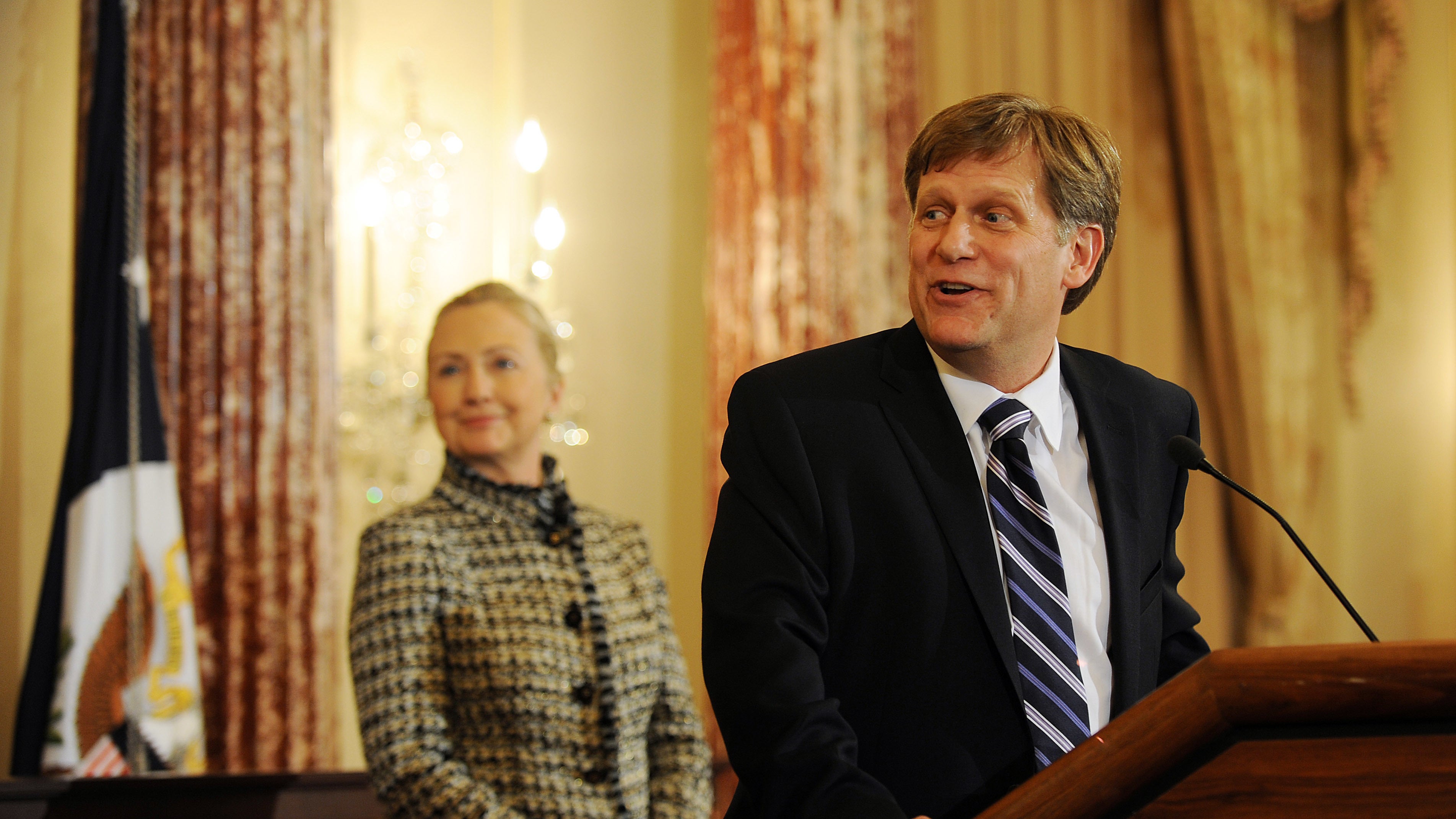 U.S. Secretary of State Hillary Clinton smiles at a remark made by Ambassador-Designate to Russia Michael McFaul during his swearing-in ceremony at the State Department on January 10, 2011, in Washington, D.C.