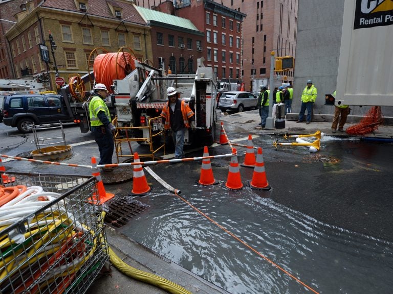 Verizon crews pump water from an access tunnel in Manhattan in 2012 after flooding from Superstorm Sandy knocked out underground Internet cables. (Stan Honda/AFP/Getty Images)