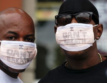 New York City police are giving the Justice Department a deadline to announce criminal charges in the 2014 death of Eric Garner. Garner's death spurred protests, including by two men who wore medical masks reading 