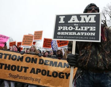 Dueling protesters at a March for Life rally in 2016. Only 17 percent say they want the landmark Roe v. Wade ruling overturned, a new NPR/PBS NewsHour/Marist poll finds. (Alex Wong/Getty Images)
